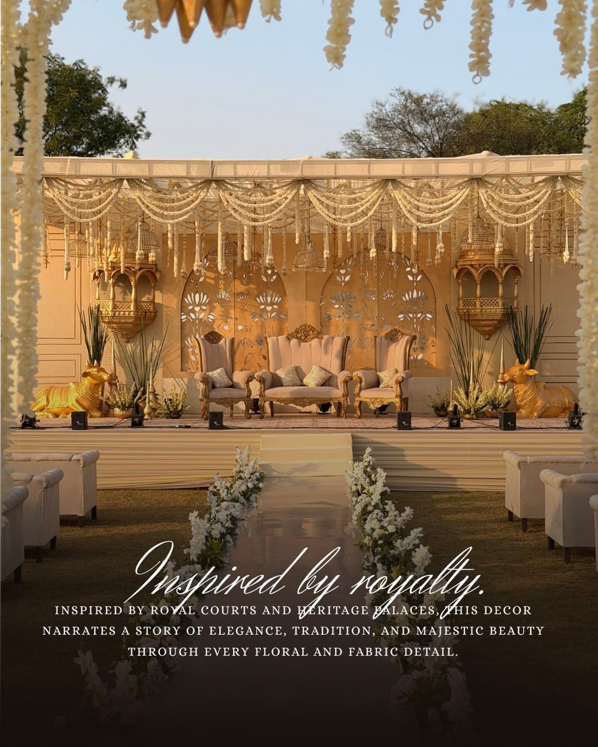Royal heritage-inspired wedding stage with golden jharokhas, hanging florals and seating