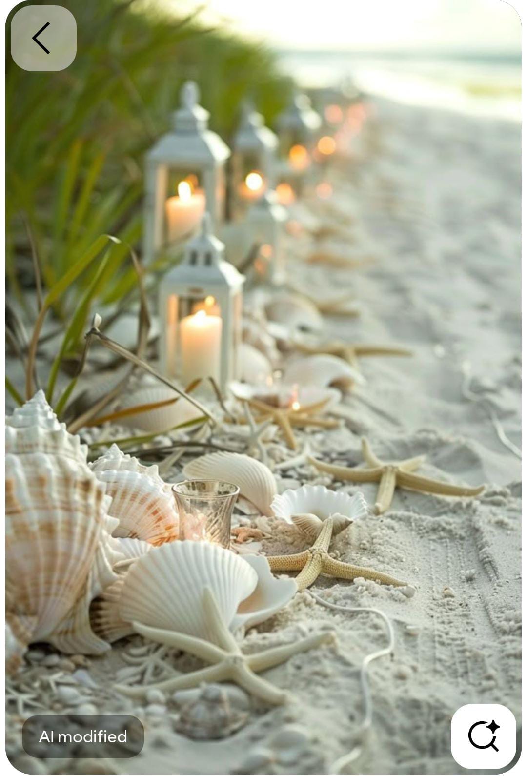 White lanterns, seashells and starfish arranged along a sandy beach aisle